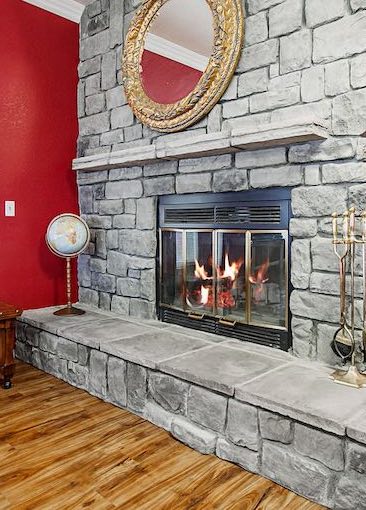 Stone Fireplace with Mirror and Globe