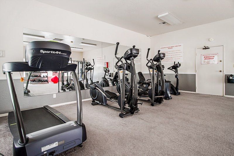 Gym Room with Treadmills, Ellipticals, and Stationary Bike