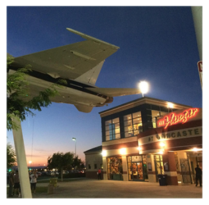 Suspended large displayed airplane and building with text "The Hangar at Lancaster" Baseball Stadium