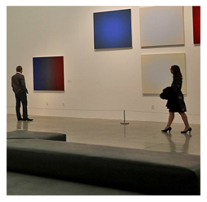 Two patrons observe large colorful canvases at the Museum of Art and History